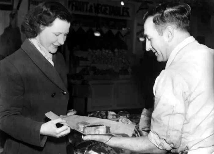 Framed Print : Post World War Two - Second World War - A woman collects her meat ration from a butcher