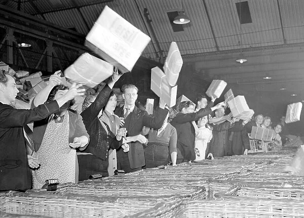 Postal workers in a West London sorting office seen here sorting the next delivery of