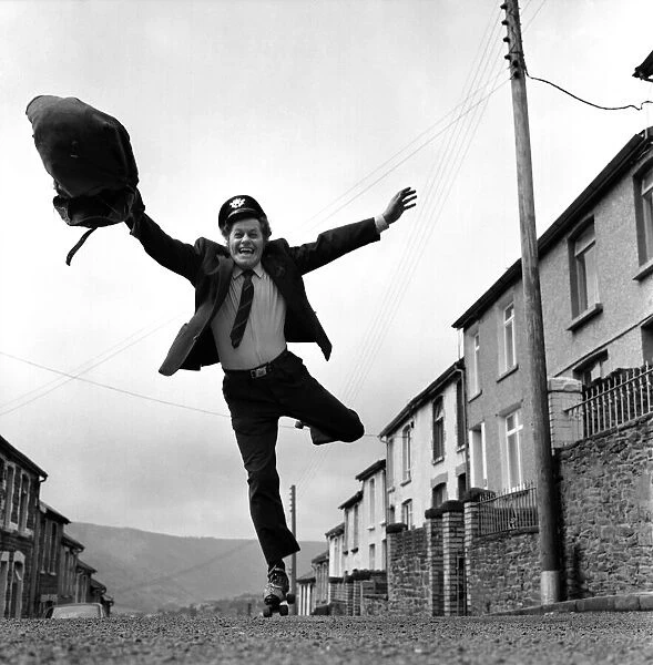 Postman Mr. Fred Henderson in happy mood as he delivers his mail. April 1975