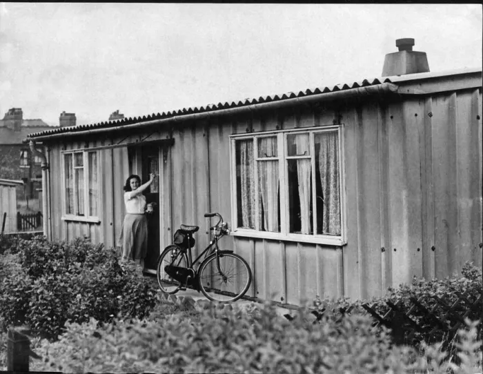 Framed Print : Prefab Bungalows Prefab Housing. A young lady rests her bicycle
