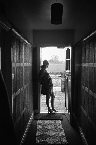 A pregnant woman standing in a doorway. 3rd May 1968