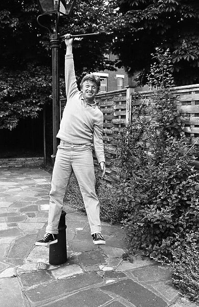 President of Bermondsey Boat Club Tommy Steele relaxes at his Thames side house at