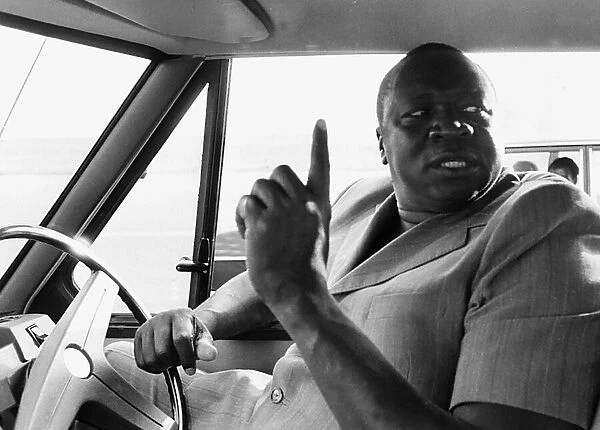 President Idi Amin at the wheel of his Range Rover at Entebbe Airport near Kampala