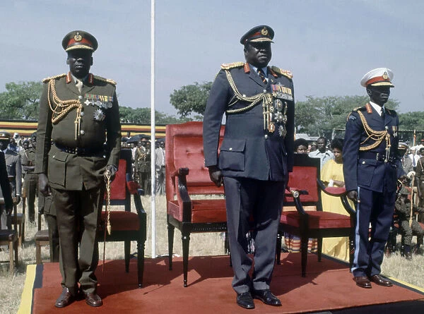 President of Uganda, General Idi Amin, pictured in military uniform flanked by officers