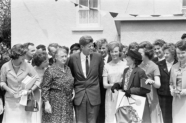 President of the United States John F. Kennedy shares a joke with relations