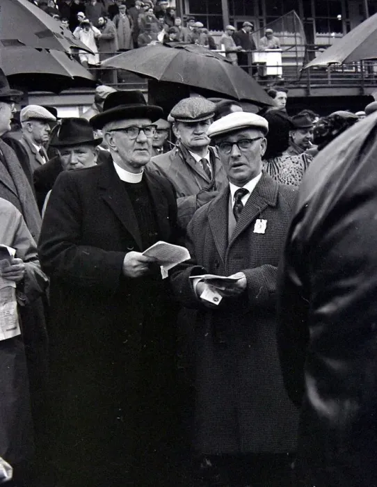 Framed Print : A priest holds his guide during a day out at the races in Cheltenham March 1963