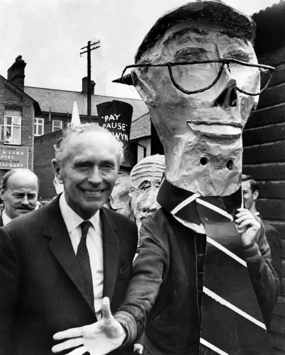 Framed Print : The Prime Minister, Alec Douglas-Home rejects the hand of somebody wearing a mask of Framed Print : The Prime Minister, Alec Douglas-Home rejects the hand of somebody wearing a mask of