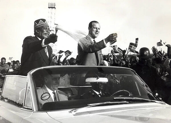 The Prime Minister of Kenya, Jomo Kenyatta drives through a crowd of people while