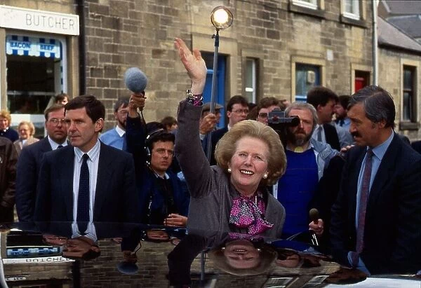 Prime Minister Margaret Thatcher waves to crowds outside Houstons the bakers during a