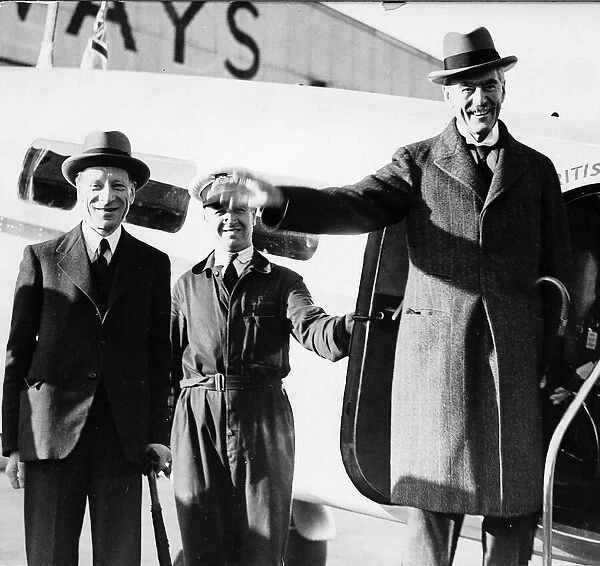 Prime Minister Neville Chamberlain steps off a plane wearing an overcoat and a hat