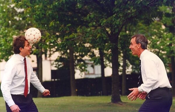 Prime Minister Tony Blair and ex FIFA football referee George Courtney play football at