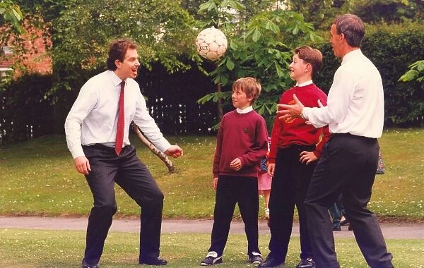 Prime Minister Tony Blair and ex FIFA football referee George Courtney play football at