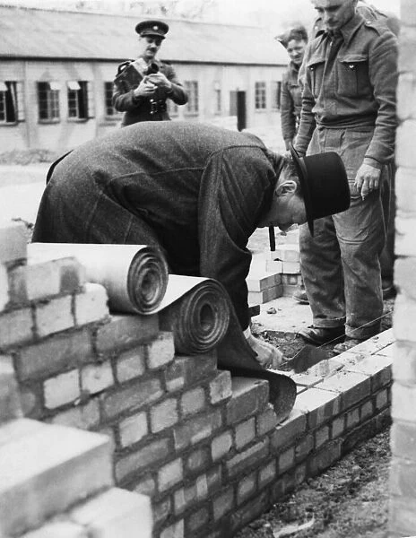 Prime Minister Winston Churchill in action as bricklayer