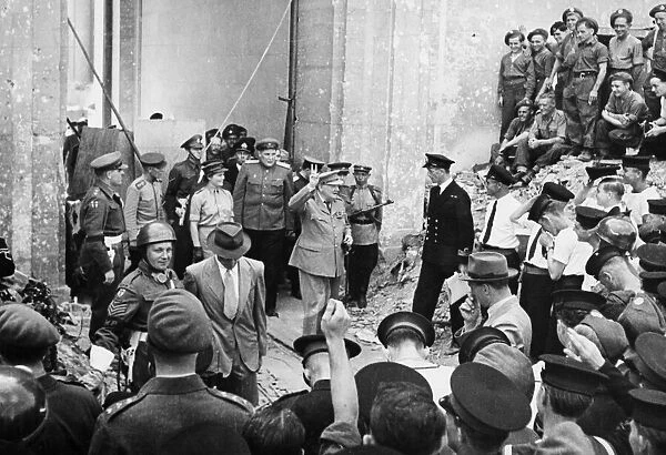 Prime Minister Winston Churchill leaving the ruined Reich Chancellery while giving