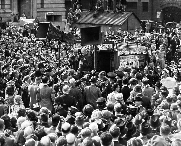Prime Minister Winston Churchill surrounded by huge crowds of people on his visit to