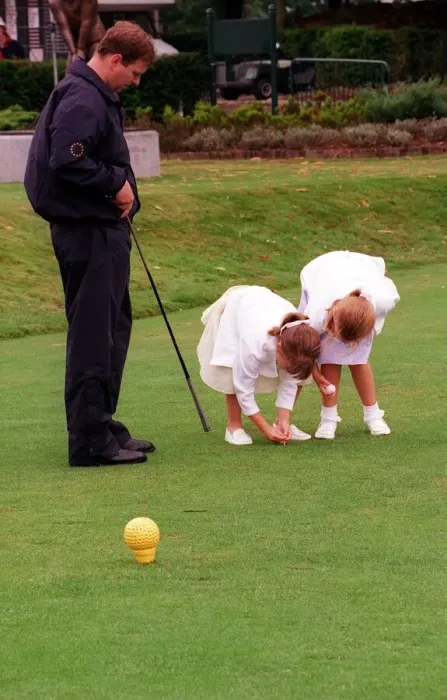 Framed Print : Prince Andrew and daughters Beatrice (R) and Eugenie, August 1998 Placing a golf