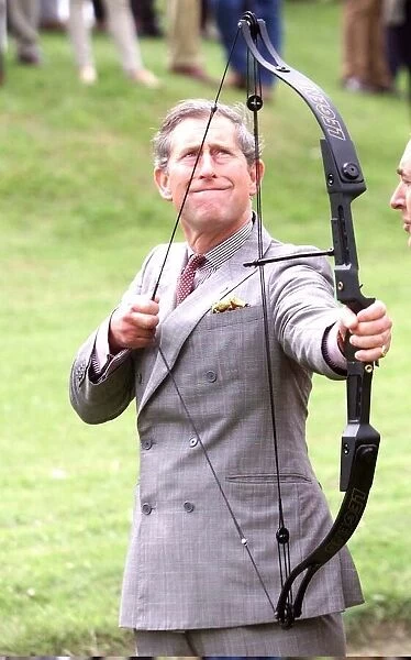 Prince Charles with bow and arrow at archery practice at clay pigeon shoot to raise money