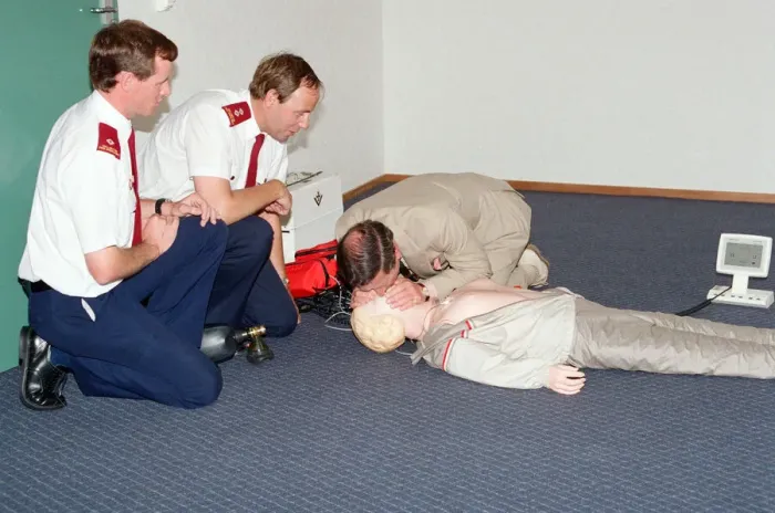 Framed Print : Prince Charles demonstrating resuscitation techniques on an inflatable doll at an
