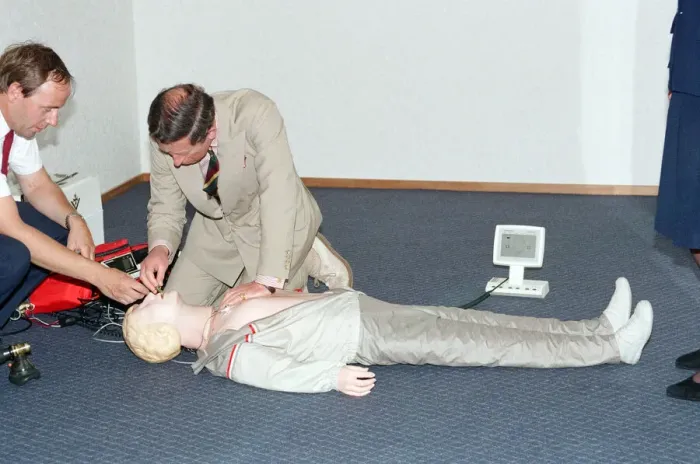 Framed Print : Prince Charles demonstrating resuscitation techniques on an inflatable doll at an Framed Print : Prince Charles demonstrating resuscitation techniques on an inflatable doll at an