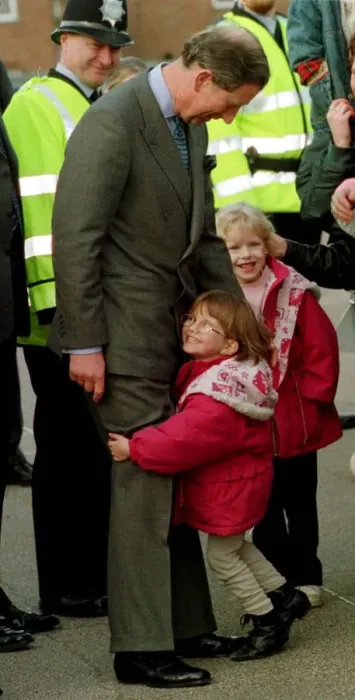 Framed Print : Prince Charles gets an unexpected hug from four year old Sarah Norris during a school Framed Print : Prince Charles gets an unexpected hug from four year old Sarah Norris during a school