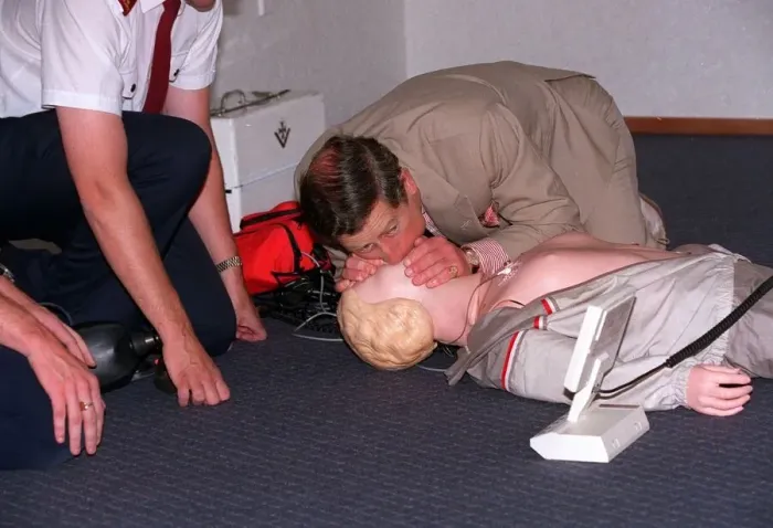 Framed Print : Prince Charles getting up close and personal with a rescussitation dummy Framed Print : Prince Charles getting up close and personal with a rescussitation dummy