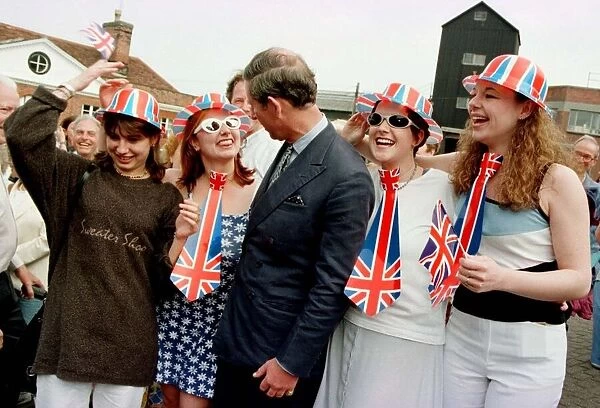 Prince Charles is greeted by a group of local residents (dressed for the occasion