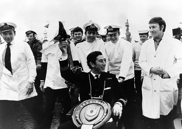 Prince Charles leaves the Navy for good in December 1976 with toilet seat round his