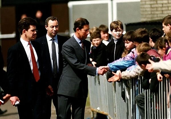 Prince Charles Prince of Wales shaking hands over barrier visit St Leonards school