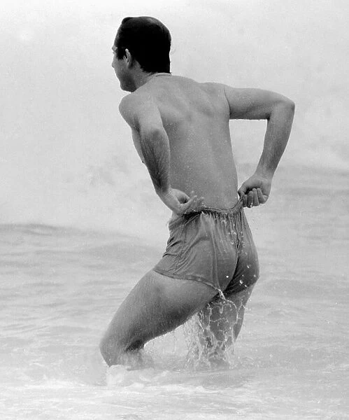 Prince Charles pulling up his shorts on a beach in Australia royal Prince of