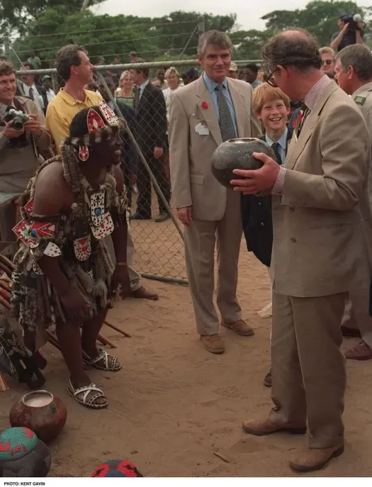Framed Print : Prince Charles samples the native drink whilst his son Prince Harry watches on their Framed Print : Prince Charles samples the native drink whilst his son Prince Harry watches on their