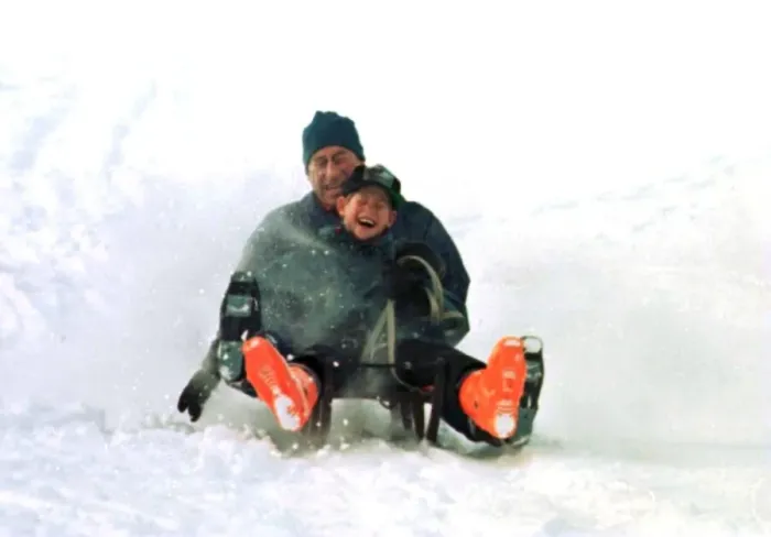 Framed Print : Prince Charles on a sledge with Prince Harry while on holiday in Klosters Framed Print : Prince Charles on a sledge with Prince Harry while on holiday in Klosters