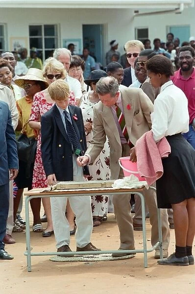 Prince Charles and his son Prince Harry visit the village of Dukuduku in South Africa