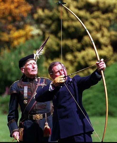 Prince Charles trys his hand at archery with the Royal Company of Archers