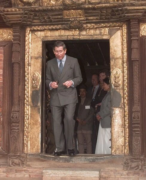 Prince Charles walking through a low temple door during his visit to Kathmandu in Nepal