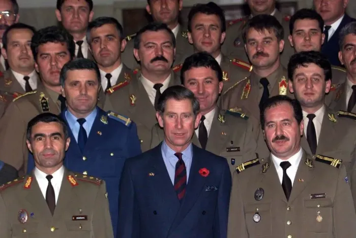 Framed Print : Prince Charles wearing a blue suit with poppy stands among officers Framed Print : Prince Charles wearing a blue suit with poppy stands among officers