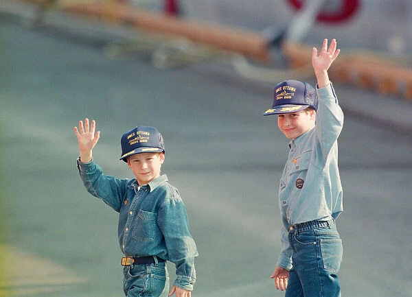 Prince Harry (left) and Prince William (right) wave to the cameras during their tour of