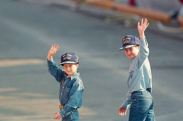 Prince Harry (left) and Prince William (right) wave to the cameras during their tour of