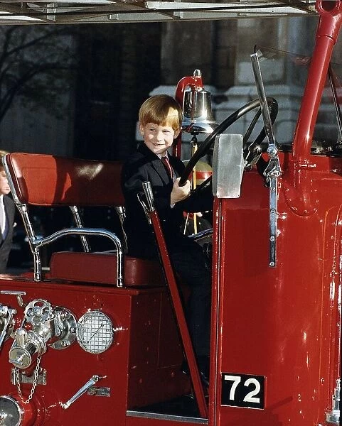 Prince Harry sitting at the wheel of a 1937 fire engine October 1990