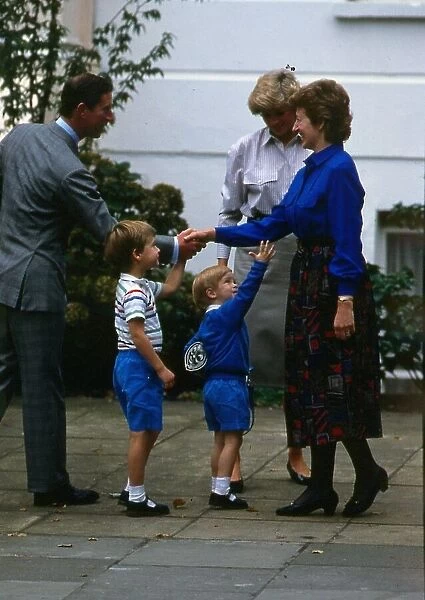Prince Harry, wearing a blue sweatshirt shorts and Thomas the Tank Engine bag