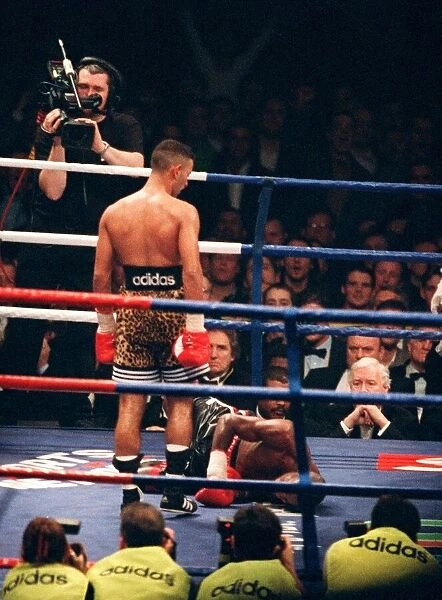Prince Naseem Hamed looks down at Tom Boom Boom Johnson after knocking him to the canvas