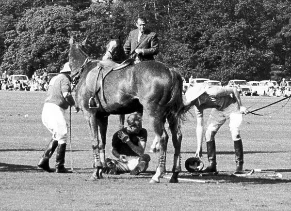 Prince Philip crouches beneath his Horse Lightening after he colided with three others