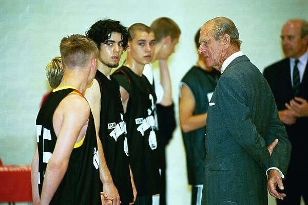 Prince Philip, Duke of Edinburgh, chats to the basketball players at the Washington