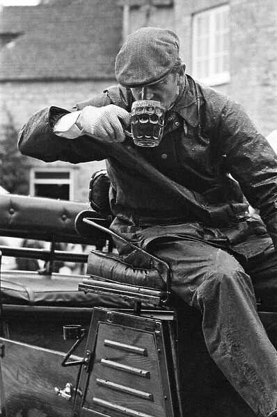Prince Philip, Duke of Edinburgh, enjoying a pint of beer as he sits on his carriage
