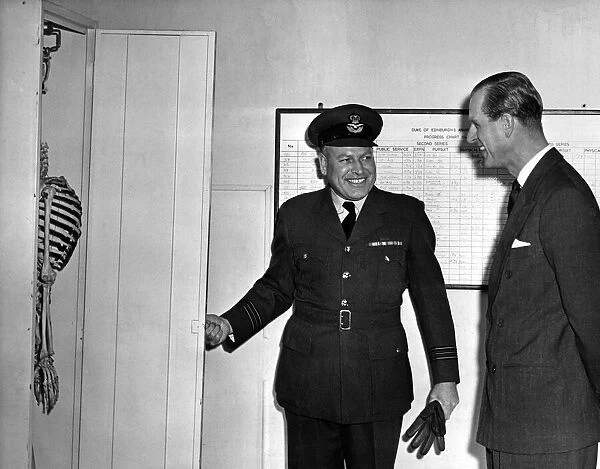 Prince Philip, the Duke of Edinburgh enjoys the joke played upon him in one of the huts