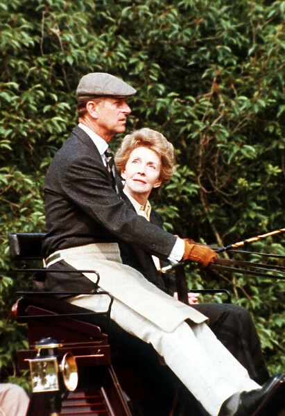 Prince Philip, the Duke of Edinburgh and Nancy Reagan sitting in a carriage driving in