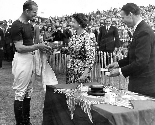 Prince Philip, Duke of Edinburgh, is presented with the Invitation Challenge Polo trophy