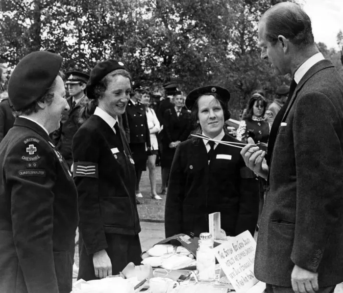 Framed Print : Prince Philip, Duke of Edinburgh, questions one of the Red Cress Cadets about the use of Framed Print : Prince Philip, Duke of Edinburgh, questions one of the Red Cress Cadets about the use of