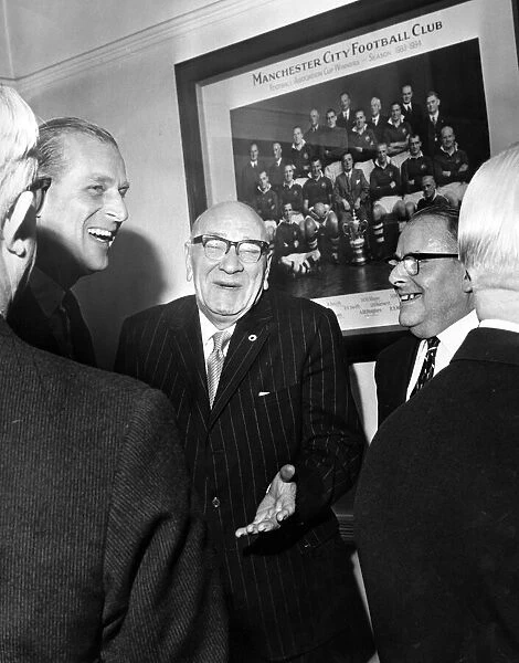 Prince Philip, Duke of Edinburgh shares a joke with Directors in the board room at Maine