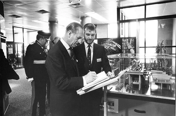Prince Philip, Duke of Edinburgh, signs the visitors