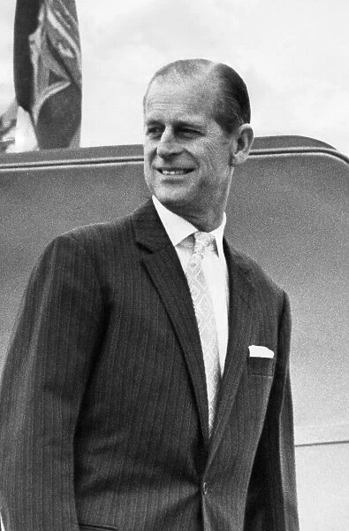Prince Philip, Duke of Edinburgh, smiles and waves as his board the aircraft